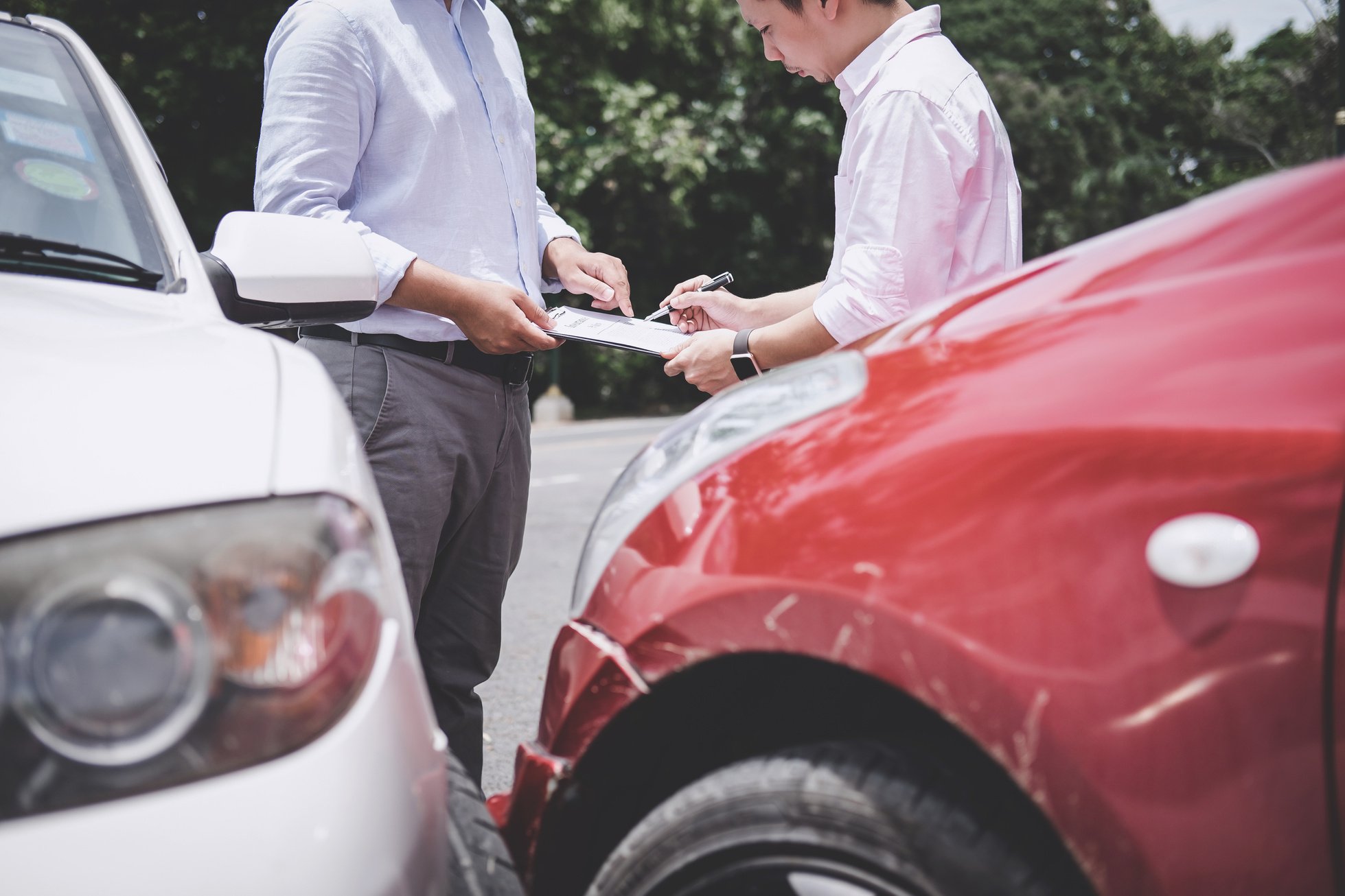 Insurance Agent Getting Signature for Damaged Car